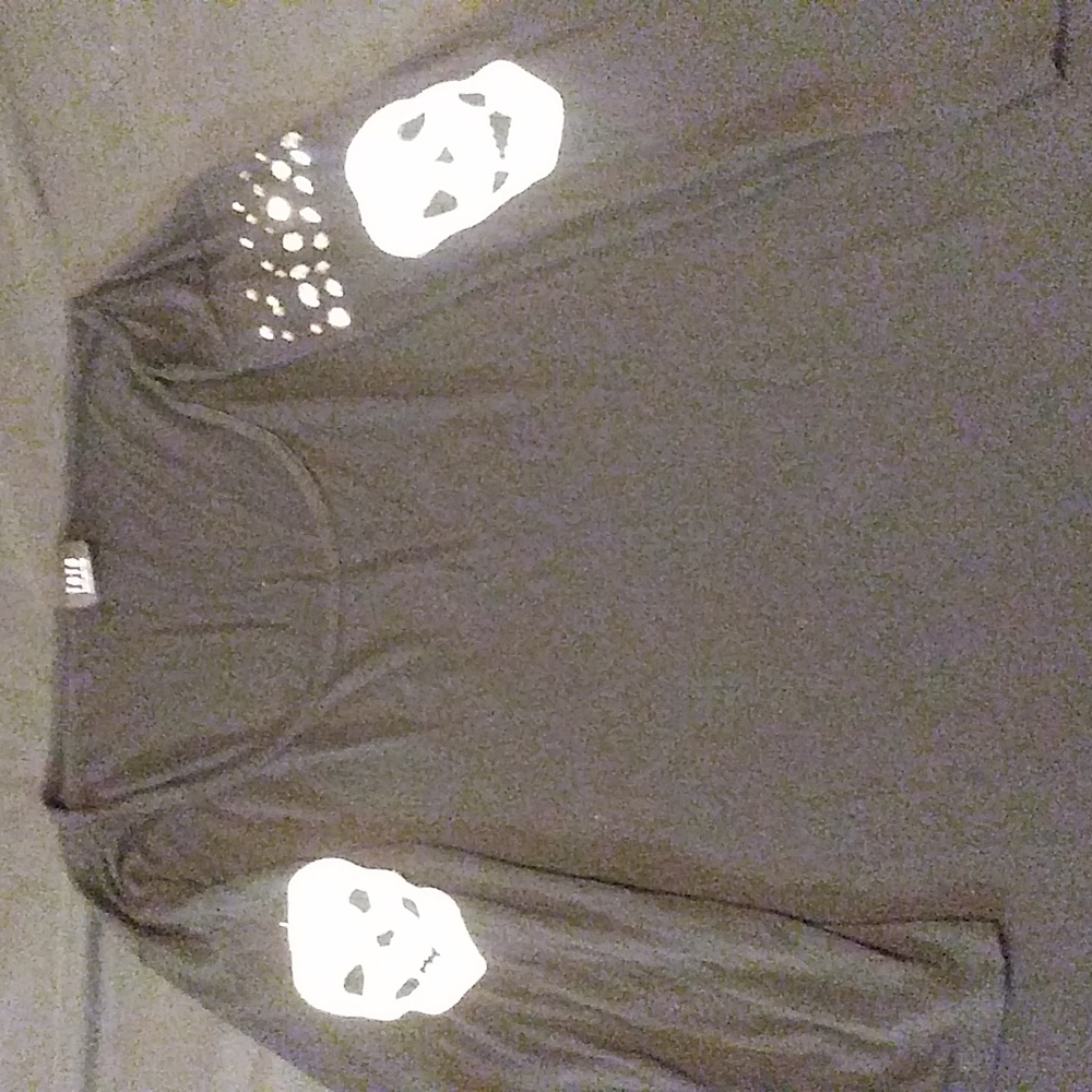 3/4 sleeve black shirt with metallic studs and crocheted skulls.
